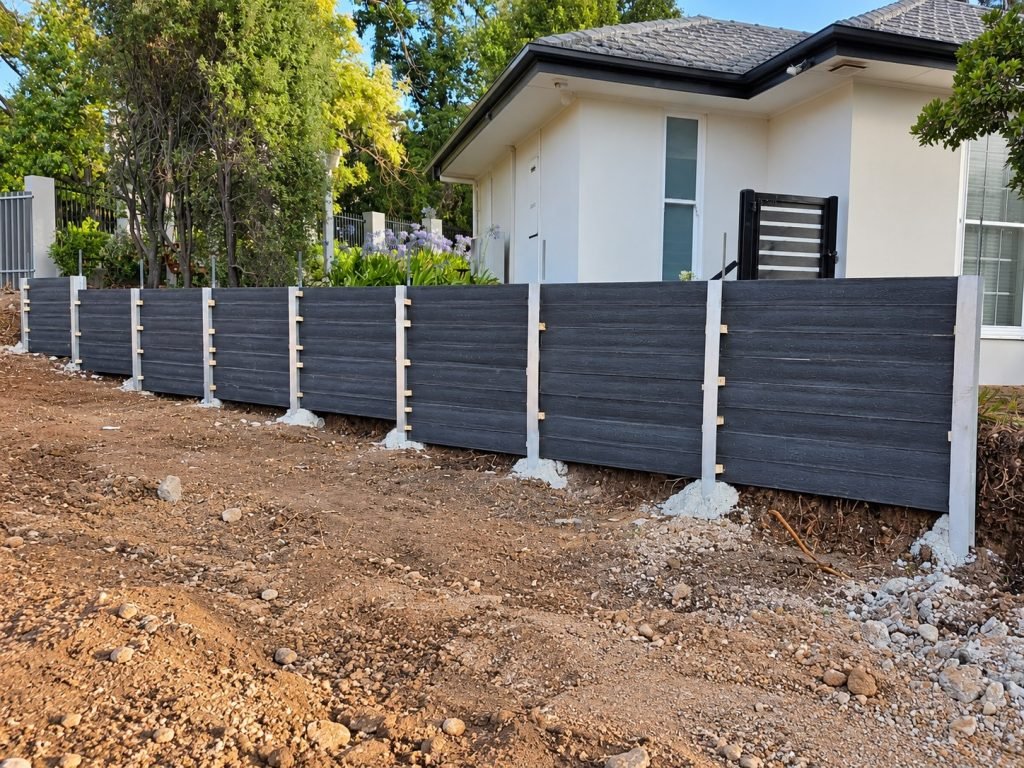 Charcoal concrete sleeper wall by Retain The Earth